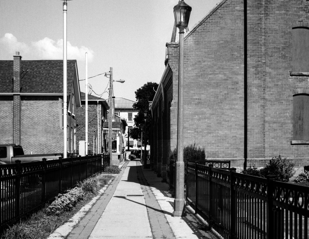 A sidewalk between two buildings