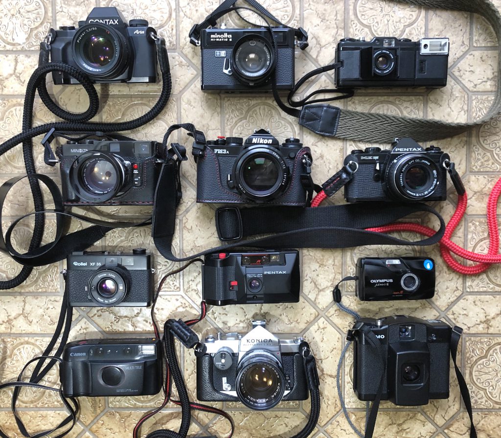 several film cameras arranged in a grid.